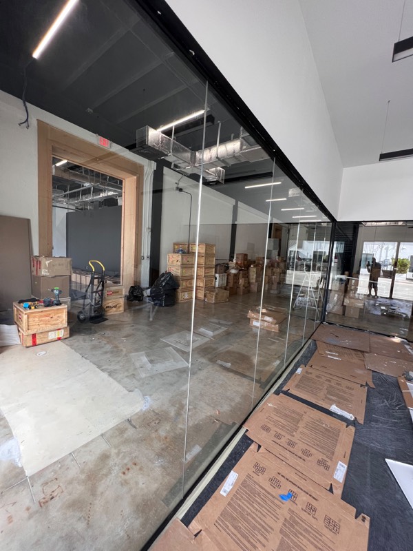 Full-height glass partition wall in a commercial unit