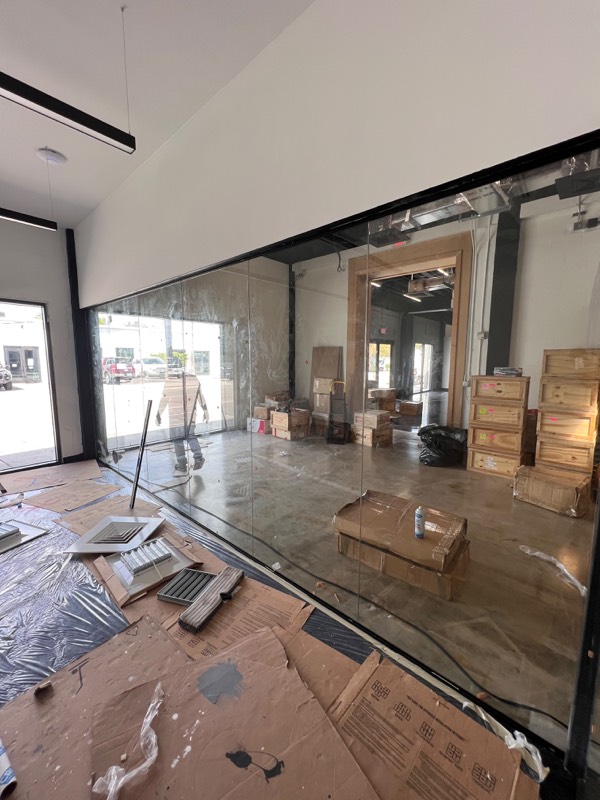 Floor to ceiling glass wall dividing a commercial space