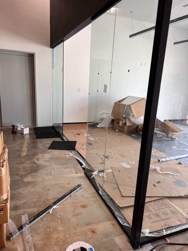 Glass wall panels and door opening during installation