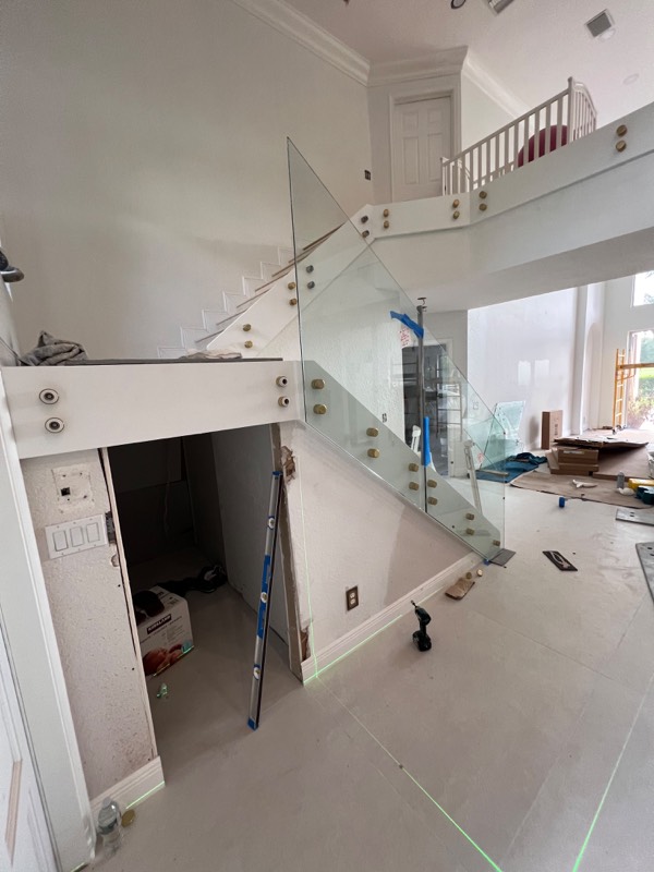 First glass railing panels mounted on gold standoffs