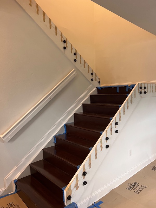 Black standoff fittings mounted along the stair stringer