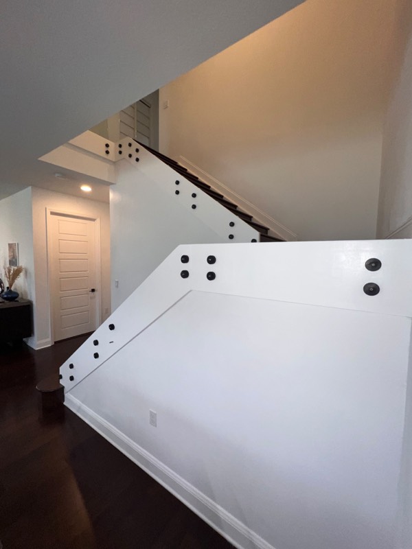 Standoff fittings set on the stair wall ready for glass