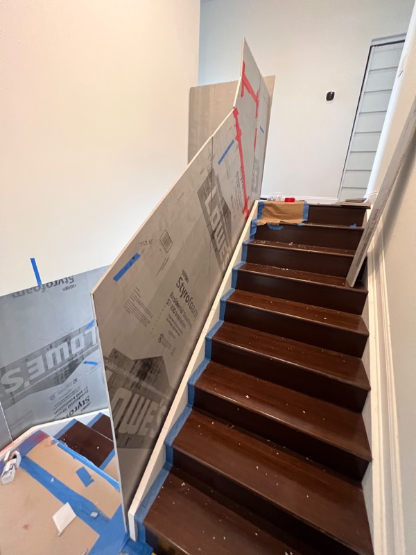 Full size templates on the stairs used to cut the glass panels