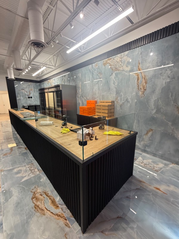 Glass panels being fitted to a shop counter