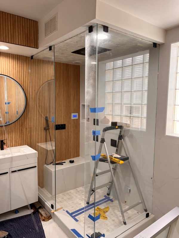 Steam shower glass panels in place during installation